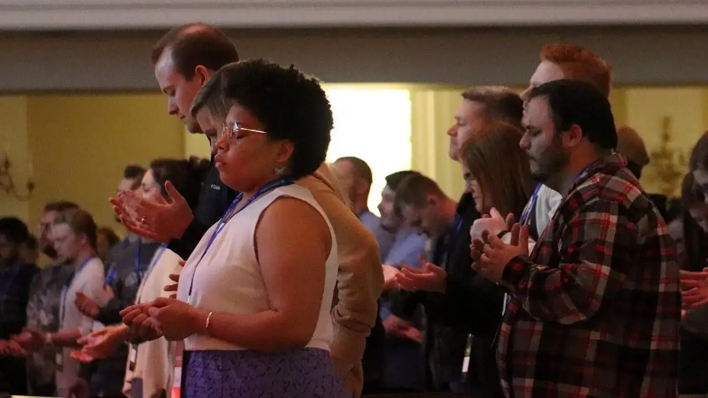 Group of people praying in worship