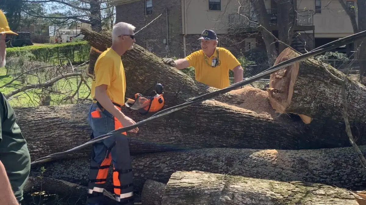 Alabama Baptist Disaster Relief chainsaw volunteers cut a fallen tree in Florence