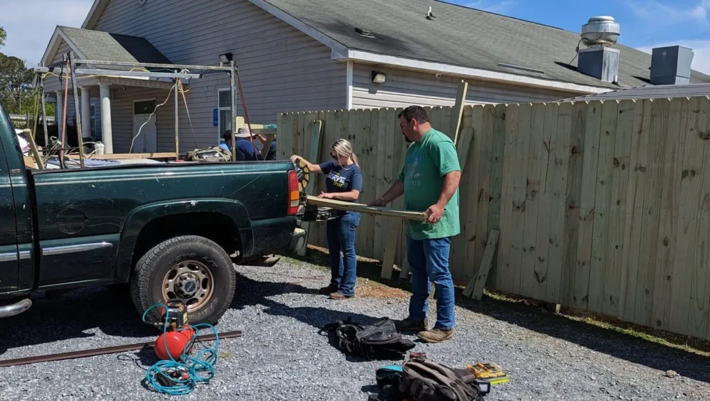 Volunteers cutting lumber at Serve Tour