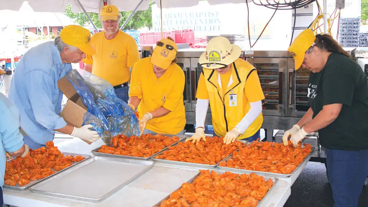 Alabama Baptist Disaster Relief volunteers prepare crawfish on tables at a feeding unit