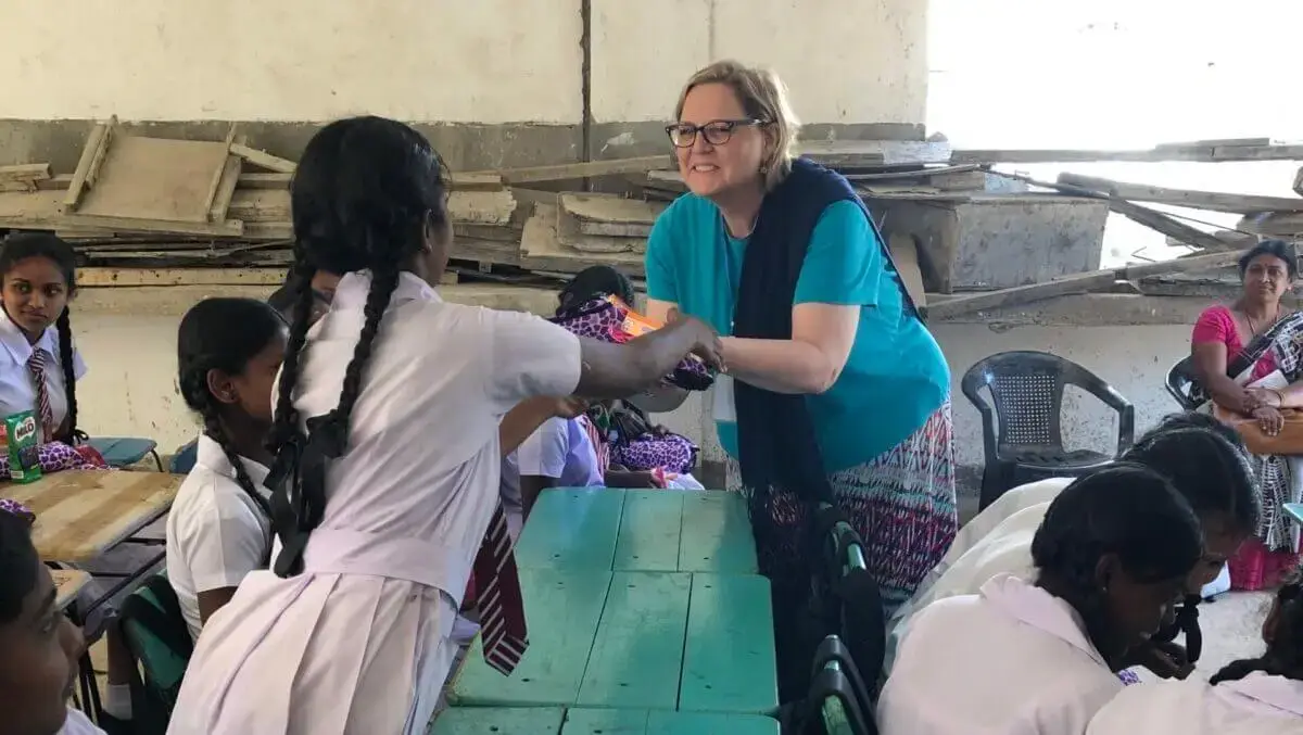 Candace McIntosh greets a young girl while on a missions trip to South Asia