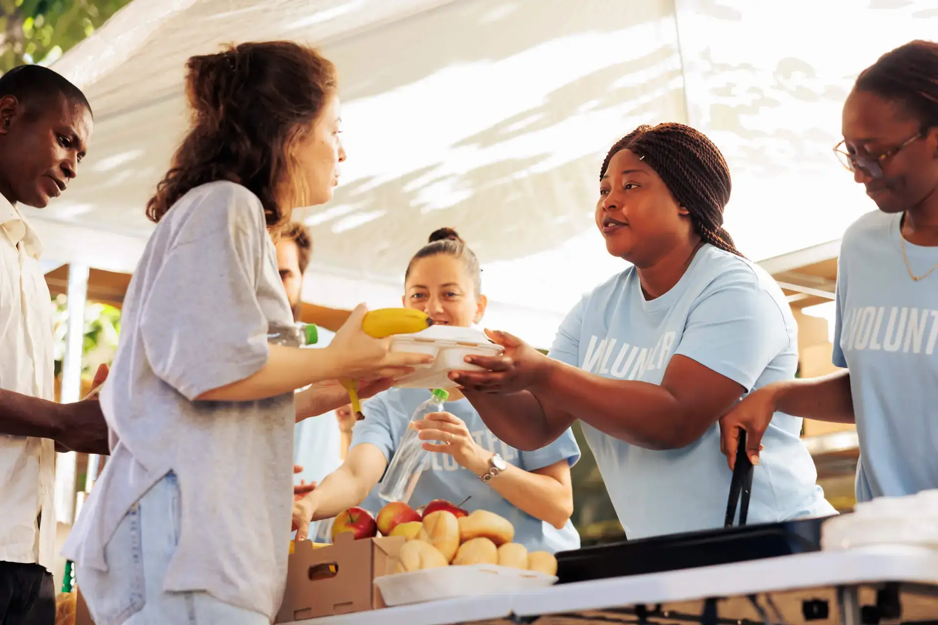 Volunteers handing out meal donations to the needy at a food drive