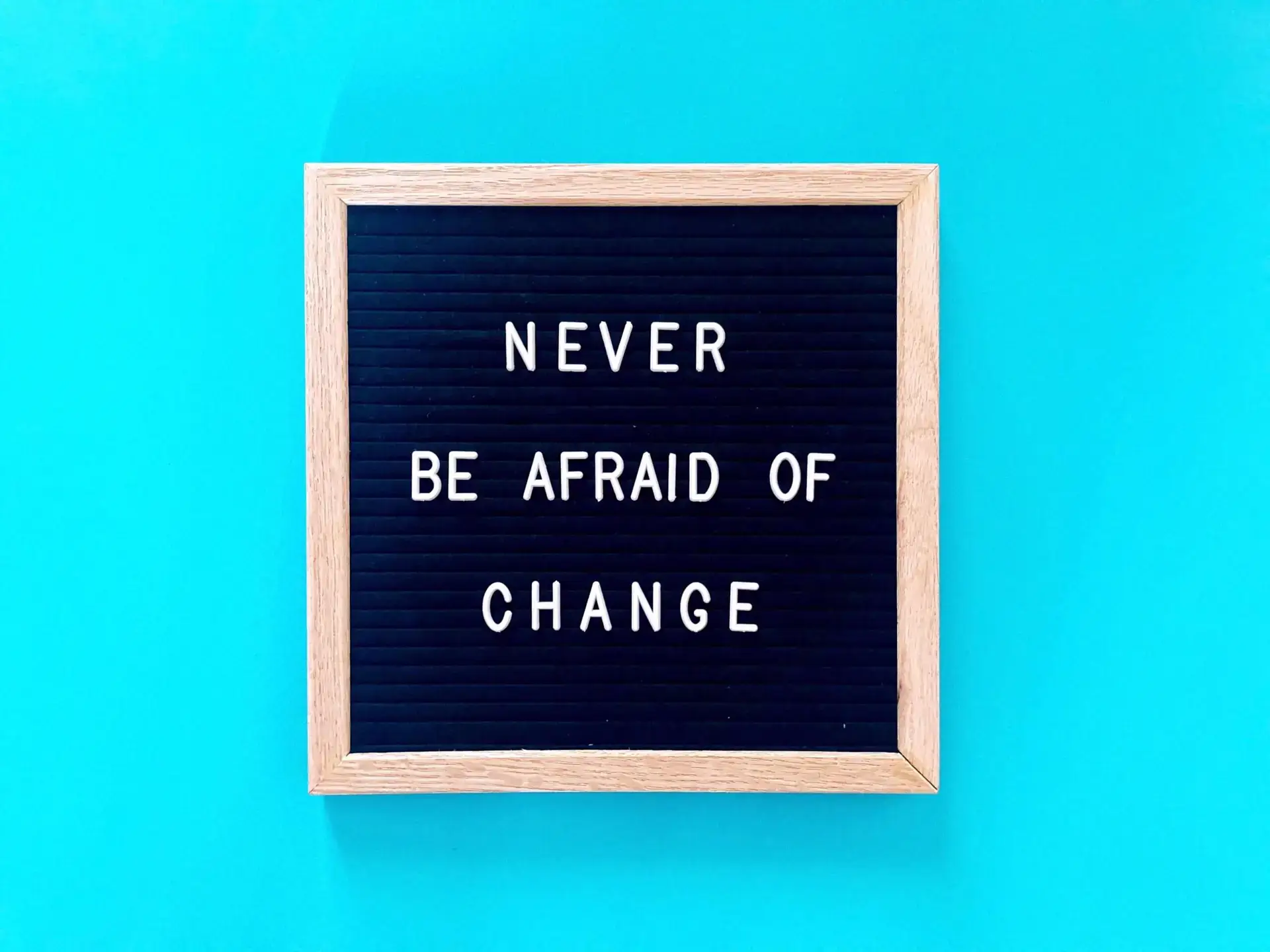 Letter board with "Never be afraid of change"