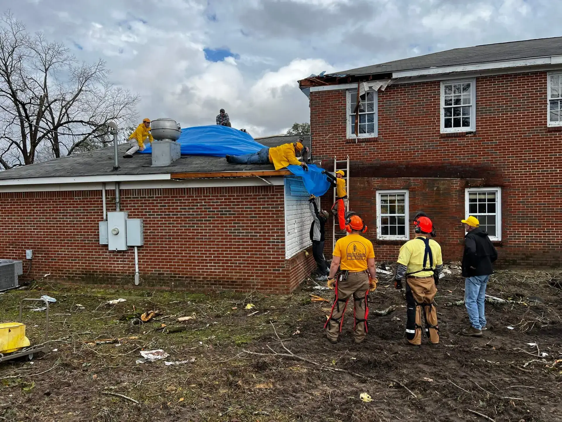 Alabama Baptist Disaster Relief volunteers tarp a roof at FBC Cottonwood after a tornado damaged the building