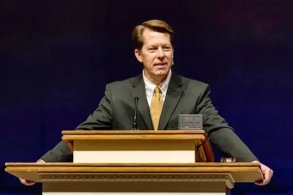 Ken Allen standing behind church pulpit