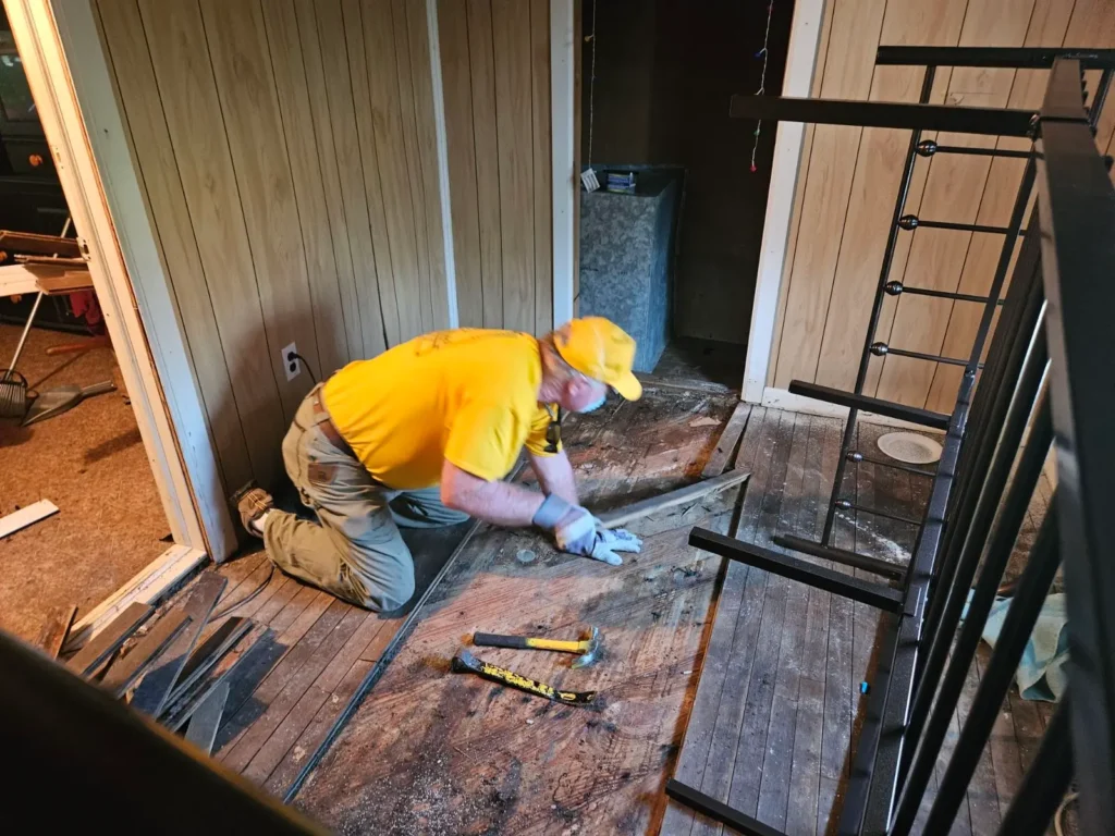 An Alabama Baptist Disaster Relief volunteer works on tearing out damaged flooring from a flooded home in Walterboro, South Carolina.