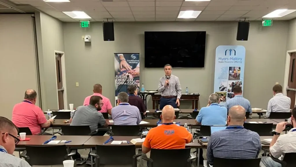 David Eldridge speaks facing a group of men at the “Intentional Leaders” series