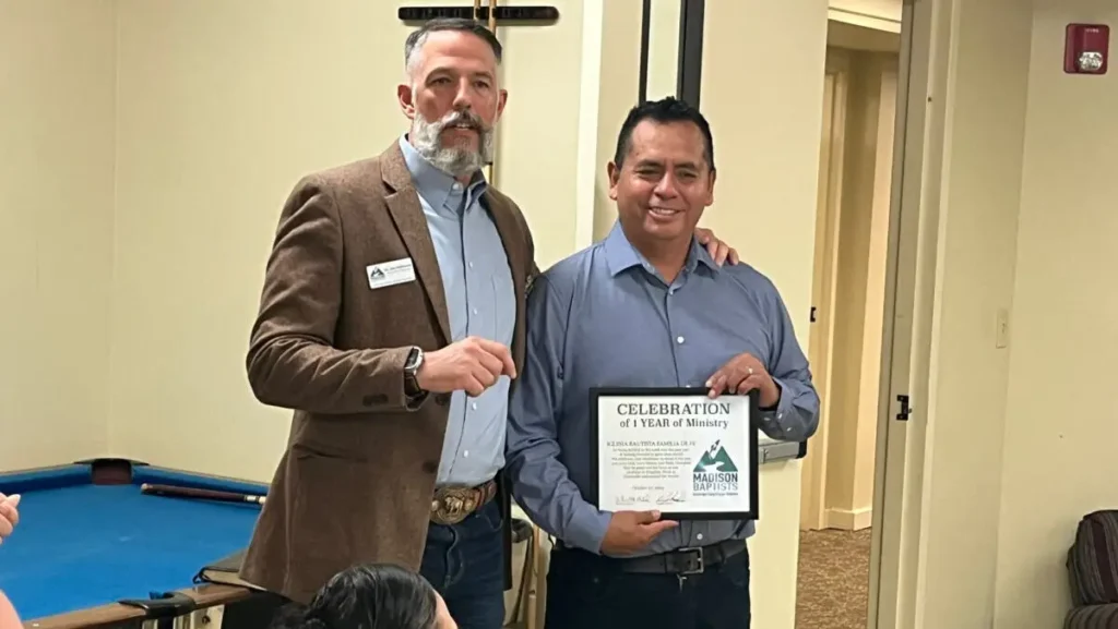 Jon Hathcock presents Pastor Humberto Medina with a certificate celebrating Iglesia Bautista Familia de Fe’s first year of ministry.