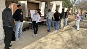 Students from Maryland/Delaware BCMs give away hot chocolate and popcorn on the campus of Auburn Unversity at Montgomery